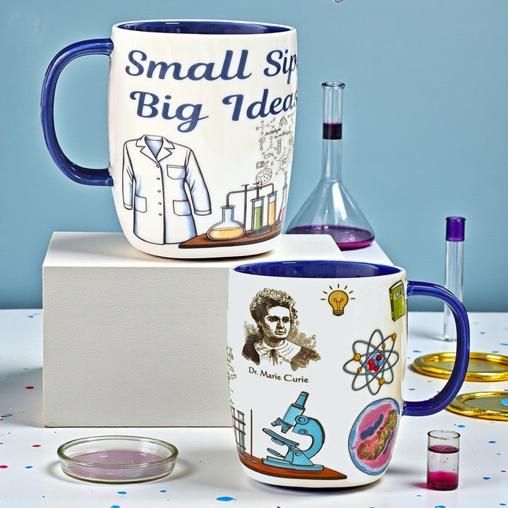 Front and back sides of a ceramic mug with scientific-themed designs and a blue handle.