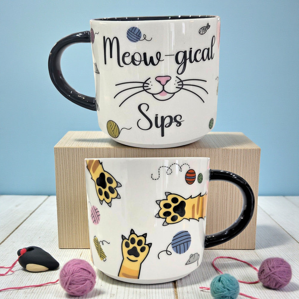 Front and back of a cat-themed ceramic mug illustrating the wrap-around design