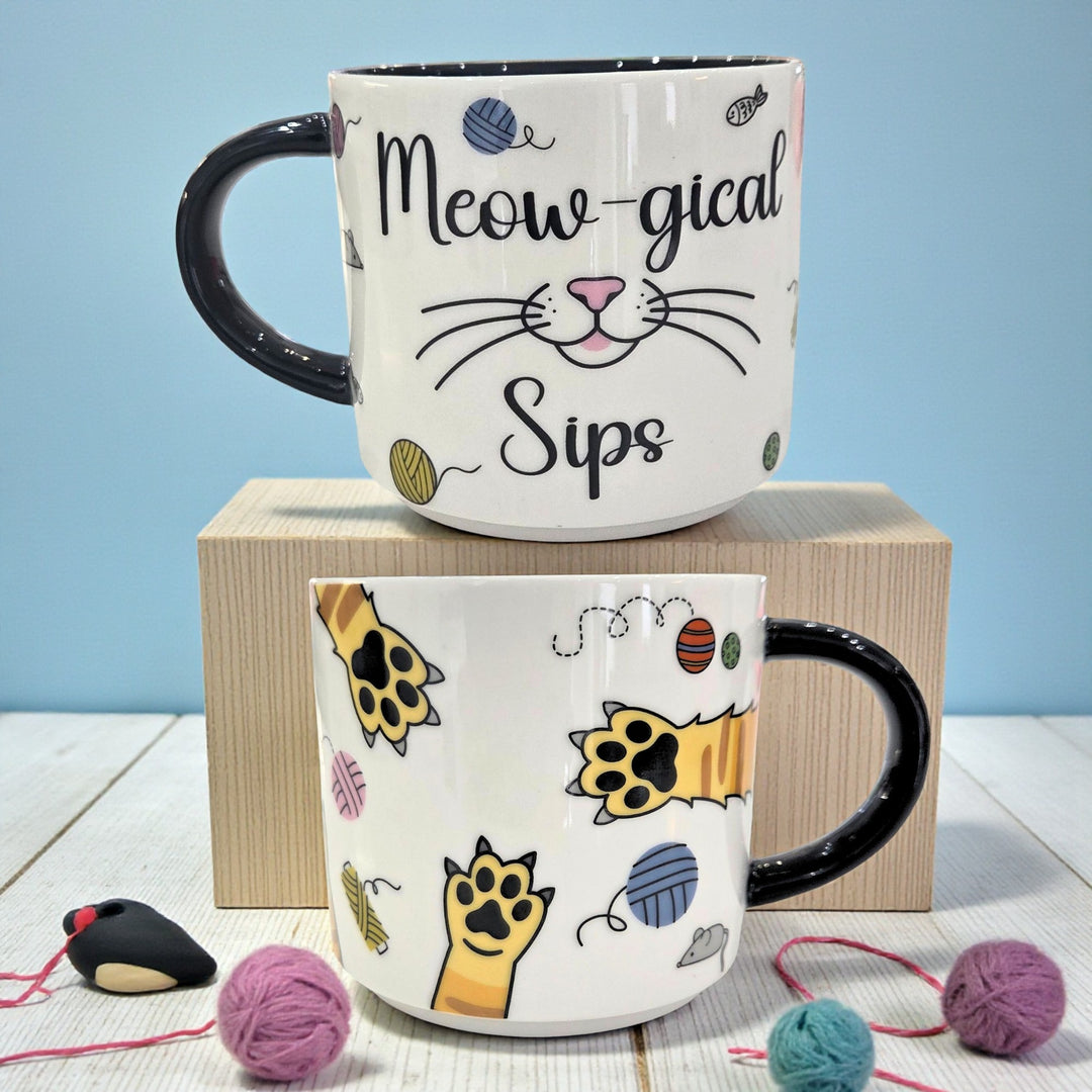 Front and back of a cat-themed ceramic mug illustrating the wrap-around design
