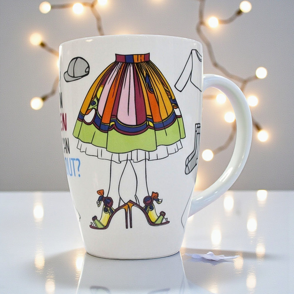 White ceramic mug with colorful skirt and shoe design on a white surface.