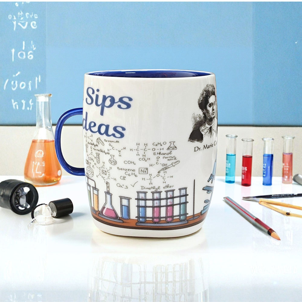 Ceramic Mug with blue handle and scientific design on a desk.