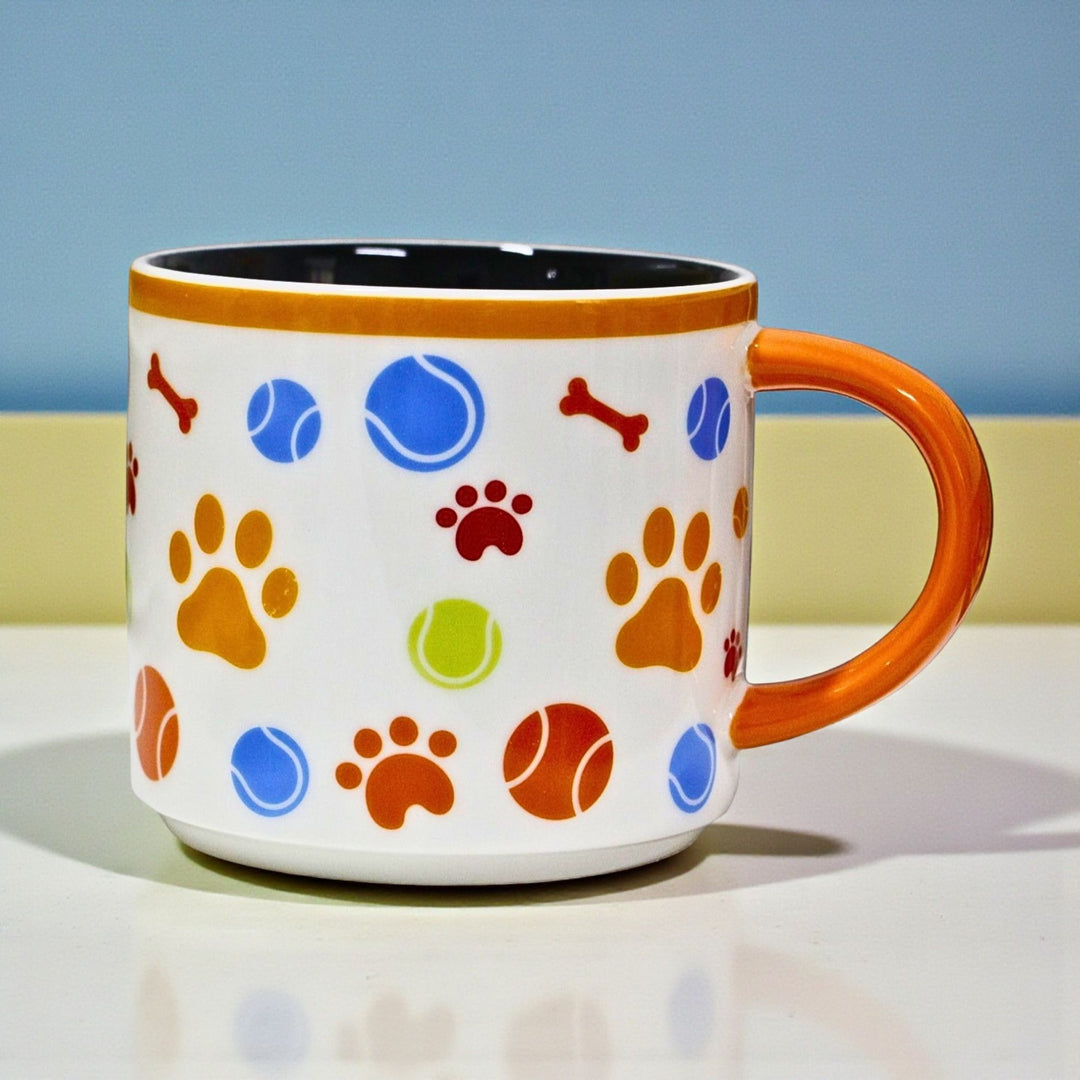White dog-themed ceramic mug with colorful paw prints and bone designs 