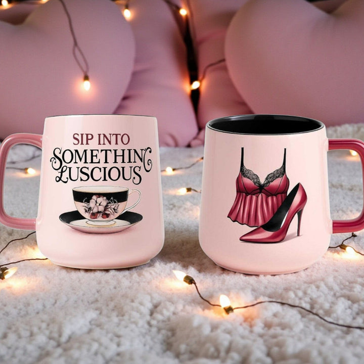Front and back of a ceramic pink mug with black interior with a tea cup and text on the front and lingerie and high heel on the back