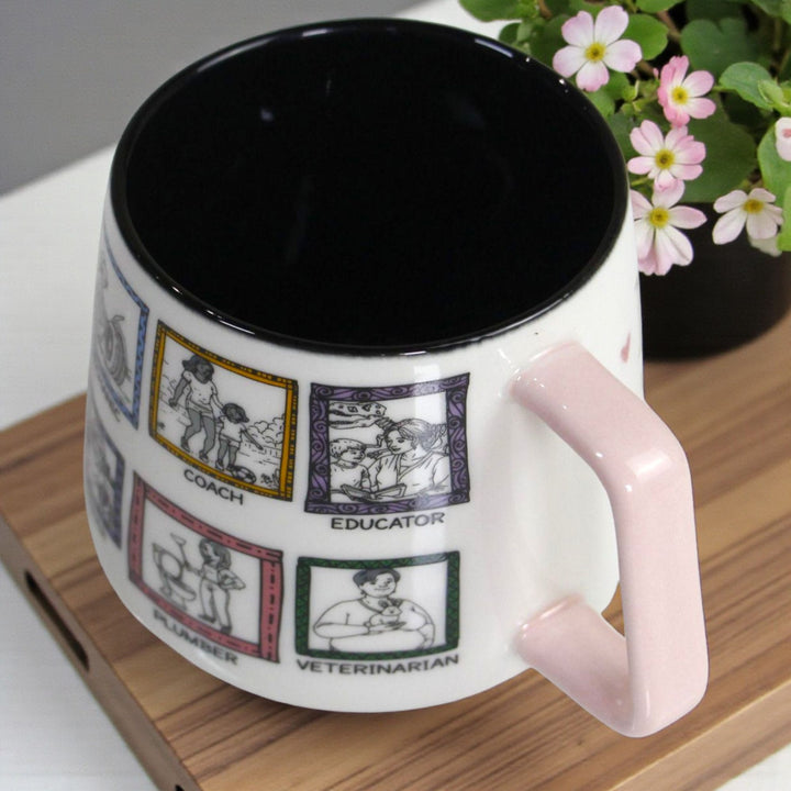 White mug with black interior, pink handle, and illustrated professions