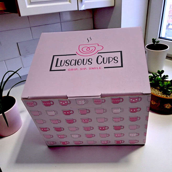 Pink box with 'Luscious Cups' branding on a kitchen counter.