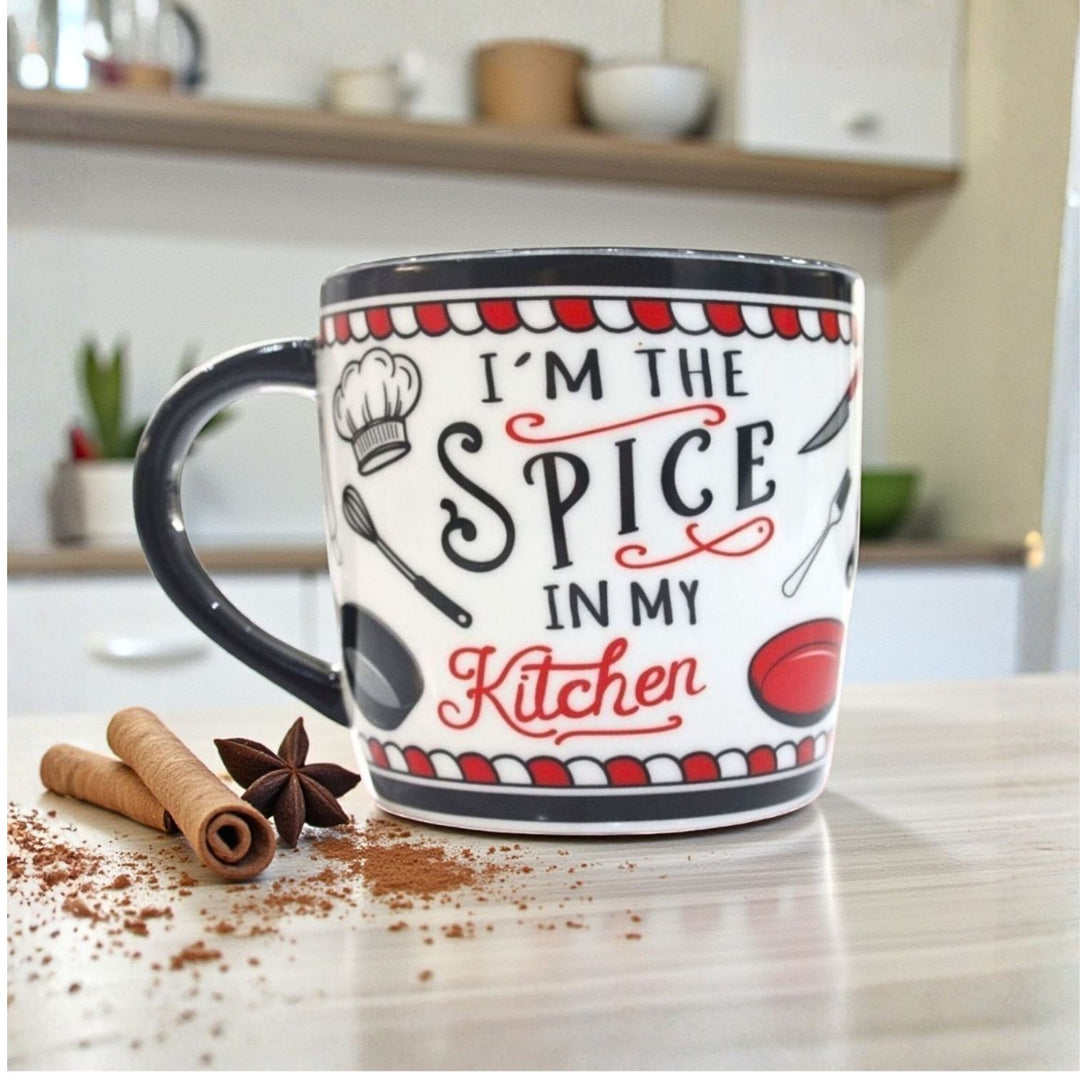 Ceramic Mug with black handle and 'I'm the spice in my kitchen' text on a kitchen counter.