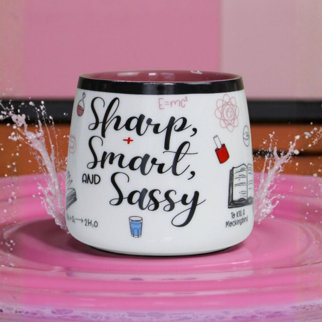 Ceramic Mug with 'Sharp, Smart, and Sassy' text on a pink background